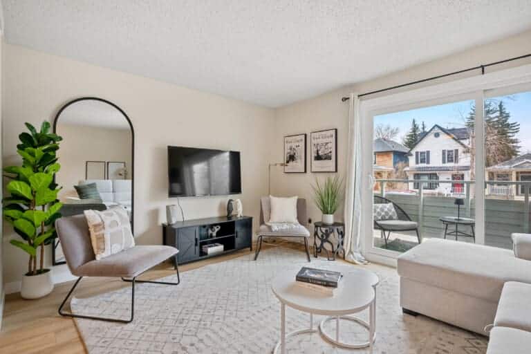 Living room with sliding doors to a balcony in a 2-bedroom Calgary apartment