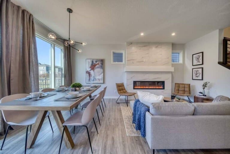 Open-plan dining and living room with electric fireplace in a 4-bedroom Calgary home