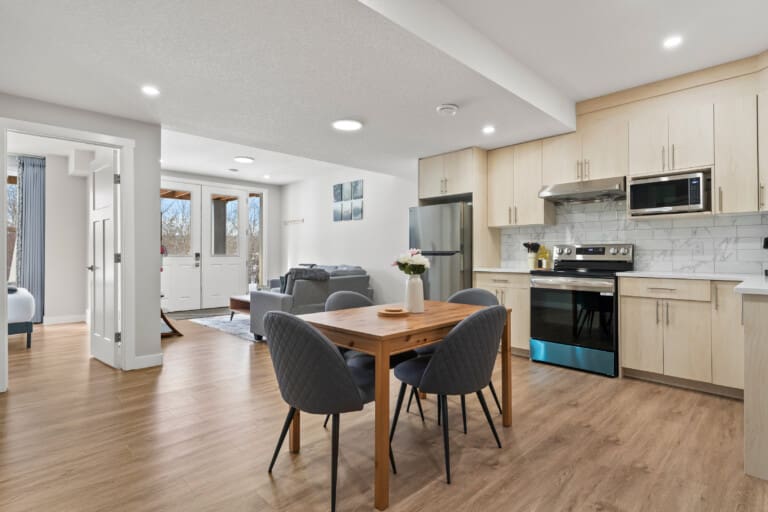 Open-plan kitchen and dining area in a 2-bedroom garden suite in SE Calgary